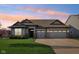 Charming one-story home with a well-manicured lawn, attached two-car garage, and neutral color scheme at 1973 Mobley Dr, Westfield, IN 46074
