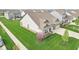 Charming home featuring lush green lawn, flowering tree, and attached two-car garage at 1973 Mobley Dr, Westfield, IN 46074