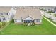 Back of home featuring covered porch, manicured landscaping, and lush green lawn at 1973 Mobley Dr, Westfield, IN 46074