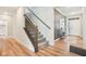 Inviting entryway featuring wood floors, staircase, and view into the front door entryway at 1973 Mobley Dr, Westfield, IN 46074