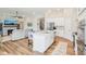Bright open concept living area with kitchen island, living room with fireplace, and staircase at 1973 Mobley Dr, Westfield, IN 46074