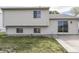 View of backyard with grass lawn and patio with sliding glass doors leading to the house at 212 Westridge Blvd, Greenwood, IN 46142