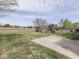 View of large, grassy backyard with a play set and a concrete patio area at 212 Westridge Blvd, Greenwood, IN 46142