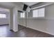 Basement bedroom with TV, closet and window, wood flooring and white trim at the floor and ceiling at 212 Westridge Blvd, Greenwood, IN 46142