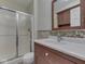 Bathroom featuring a glass shower and white sink with a dark wood vanity and granite tile countertop at 212 Westridge Blvd, Greenwood, IN 46142