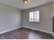 Clean bedroom with wood-look flooring and bright window at 212 Westridge Blvd, Greenwood, IN 46142