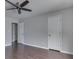 A spacious bedroom featuring wood-look flooring, a modern ceiling fan, and neutral paint at 212 Westridge Blvd, Greenwood, IN 46142