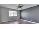 A calming bedroom with modern ceiling fan, dark accent wall, and a large window offering natural light at 212 Westridge Blvd, Greenwood, IN 46142