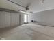 View of two car garage with white walls, white storage cabinets and a concrete floor with expansion joints at 212 Westridge Blvd, Greenwood, IN 46142