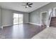 Living room boasts hardwood floors, ceiling fan and sliding glass doors at 212 Westridge Blvd, Greenwood, IN 46142