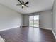 Living room boasts hardwood floors, ceiling fan and sliding glass doors at 212 Westridge Blvd, Greenwood, IN 46142
