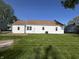 Backyard featuring a large green lawn, white siding and a blue sky at 2135 Union St, Columbus, IN 47201