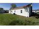 Backyard featuring a large green lawn, white siding, an air conditioner and a blue sky at 2135 Union St, Columbus, IN 47201