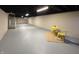 Spacious finished basement with gray painted floor, a table and exposed ceiling at 2135 Union St, Columbus, IN 47201
