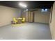 Finished basement area staged with a table, two chairs and folding screen at 2135 Union St, Columbus, IN 47201