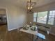 Bright dining area featuring a modern light fixture and clear chairs by a window at 2135 Union St, Columbus, IN 47201