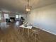 Open-concept dining area with wood floors, modern light fixture, and living room view at 2135 Union St, Columbus, IN 47201