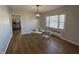 Cozy dining area with modern light fixture, wood floors, and stylish clear chairs at 2135 Union St, Columbus, IN 47201