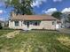 Charming stone cottage with a neatly landscaped front yard under a bright, partly cloudy sky at 2135 Union St, Columbus, IN 47201