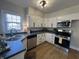 Charming kitchen with stainless steel appliances, light cabinets, and modern hardware at 2135 Union St, Columbus, IN 47201