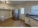 Open kitchen featuring stainless steel refrigerator and white cabinetry at 2135 Union St, Columbus, IN 47201