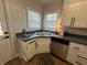 Well-lit kitchen with stainless steel appliances, and a corner sink under bright windows at 2135 Union St, Columbus, IN 47201