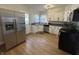 Updated kitchen with stainless steel appliances, white cabinets, and wood-look flooring at 2135 Union St, Columbus, IN 47201