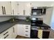 Galley kitchen with stainless steel microwave and oven, bright countertops, and natural light at 2135 Union St, Columbus, IN 47201