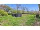 Backyard with an above ground pool surrounded by grass and mature trees at 2219 N Webster Ave, Indianapolis, IN 46219