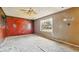 Spacious bedroom with natural light coming through the window and vintage ceiling fan at 2219 N Webster Ave, Indianapolis, IN 46219