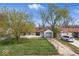 Charming single-story home featuring an attached garage and a well-maintained lawn at 2219 N Webster Ave, Indianapolis, IN 46219