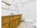 Clean bathroom with wood vanity, classic tiling, and a shower-tub combination at 225 E 36Th St, Anderson, IN 46013