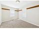 Bedroom with two windows, a ceiling light, neutral paint, and carpet at 225 E 36Th St, Anderson, IN 46013