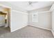 Bright bedroom with ceiling fan, neutral paint, carpet, and natural light through the window at 225 E 36Th St, Anderson, IN 46013