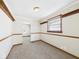 Bright dining room features neutral carpet, decorative wood trim, and lots of light at 225 E 36Th St, Anderson, IN 46013