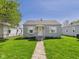 Charming single-story home featuring a well-maintained lawn and cute window awnings at 225 E 36Th St, Anderson, IN 46013