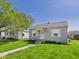 Charming single-story home featuring a well-maintained lawn and cute window awnings at 225 E 36Th St, Anderson, IN 46013