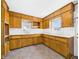 Classic kitchen with ample wooden cabinets, neutral countertops, and a bright window at 225 E 36Th St, Anderson, IN 46013