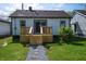 Backyard featuring a new deck with steps, complemented by a stone walkway and green grass at 241 S Rural St, Indianapolis, IN 46201