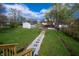 Spacious backyard featuring a stone walkway leading from the back deck through the grassy yard at 241 S Rural St, Indianapolis, IN 46201