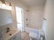A bright bathroom with white vanity, tub and toilet provides a clean and functional space at 241 S Rural St, Indianapolis, IN 46201