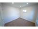 A bright bedroom with neutral carpet, closet and single window offers a peaceful retreat at 241 S Rural St, Indianapolis, IN 46201