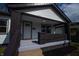 Inviting front porch with brick accents, providing a cozy entrance to the home at 241 S Rural St, Indianapolis, IN 46201