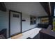 Covered front porch with a gray painted floor and a modern front door at 241 S Rural St, Indianapolis, IN 46201