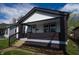Lovely home with a welcoming front porch, well-manicured landscaping, and a neat facade at 241 S Rural St, Indianapolis, IN 46201