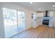 Bright kitchen with stainless steel oven, black hardware, and sliding glass doors leading to wooden deck at 241 S Rural St, Indianapolis, IN 46201