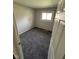 Cozy bedroom featuring gray carpet, neutral walls, and a bright window for natural light at 2448 Winfield Ave, Indianapolis, IN 46222
