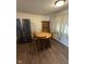 Dining area with wooden table, chairs, and hutch adjacent to a modern stainless steel refrigerator at 2448 Winfield Ave, Indianapolis, IN 46222
