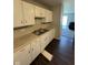 Kitchen featuring white cabinets, laminate countertops, and modern appliances at 2448 Winfield Ave, Indianapolis, IN 46222