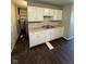 Kitchen featuring white cabinets, laminate countertops, and modern appliances at 2448 Winfield Ave, Indianapolis, IN 46222
